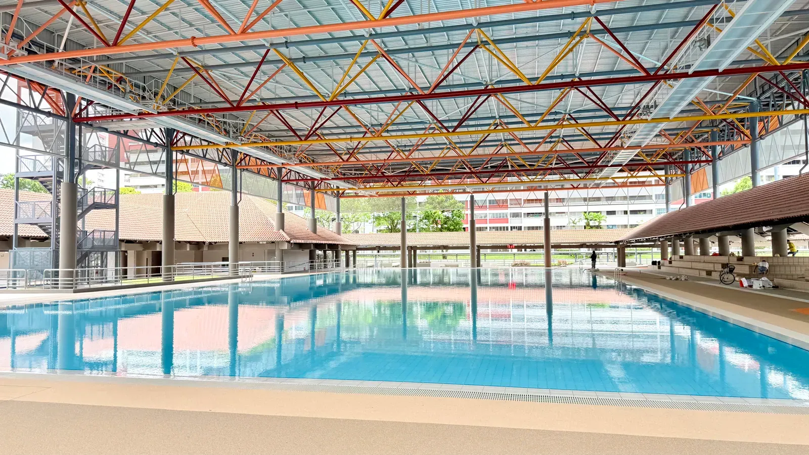 Covered sheltered teaching pool under the steel-truss roof at Hougang Swimming Complex