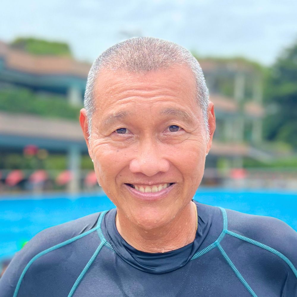 Coach James Wong standing by the swimming pool at Singapore Swimming Academy