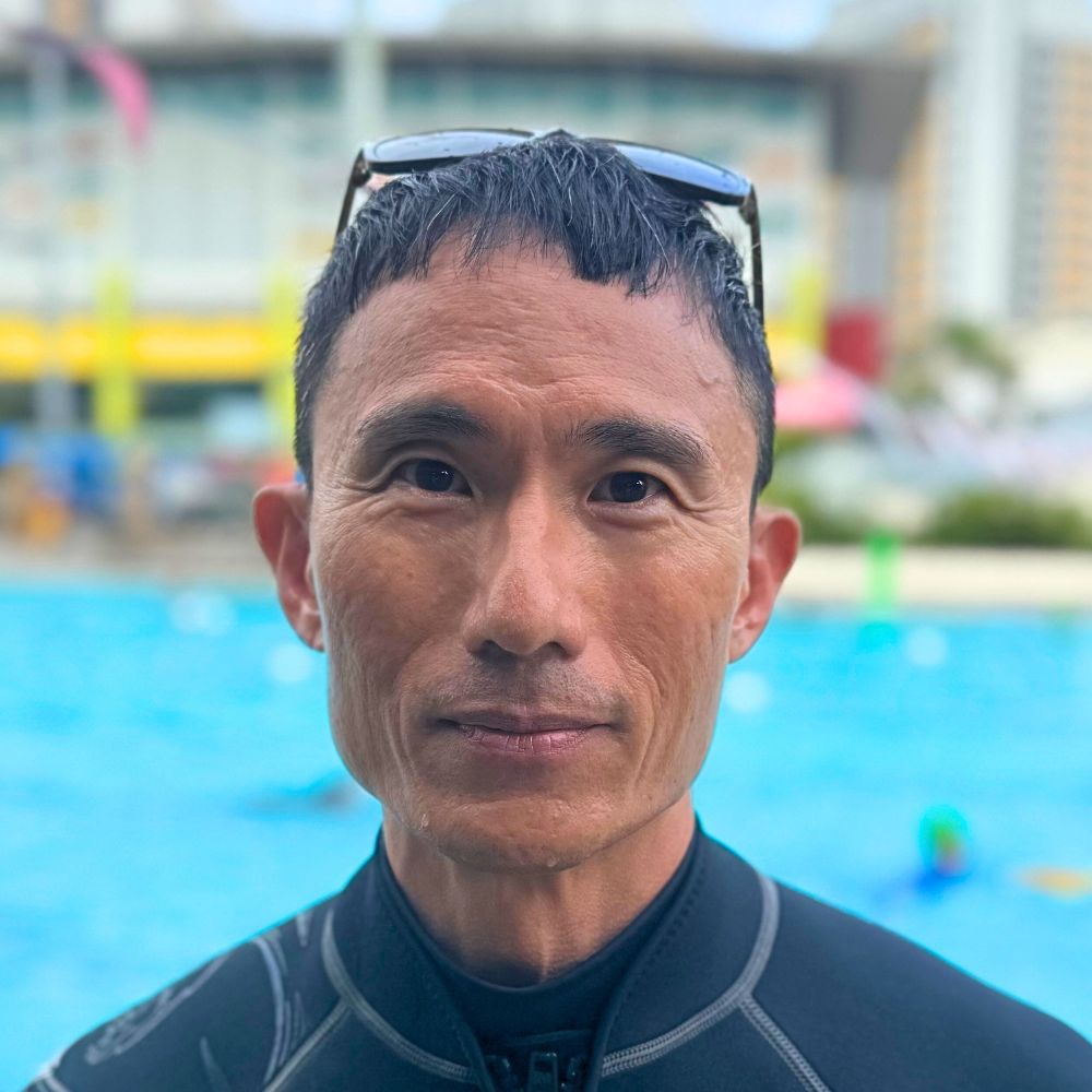 Coach Sean at the poolside of Singapore Swimming Academy during lessons