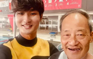 Coach Quan smiling in a selfie at the pool, known as the handsome swimming coach in Singapore
