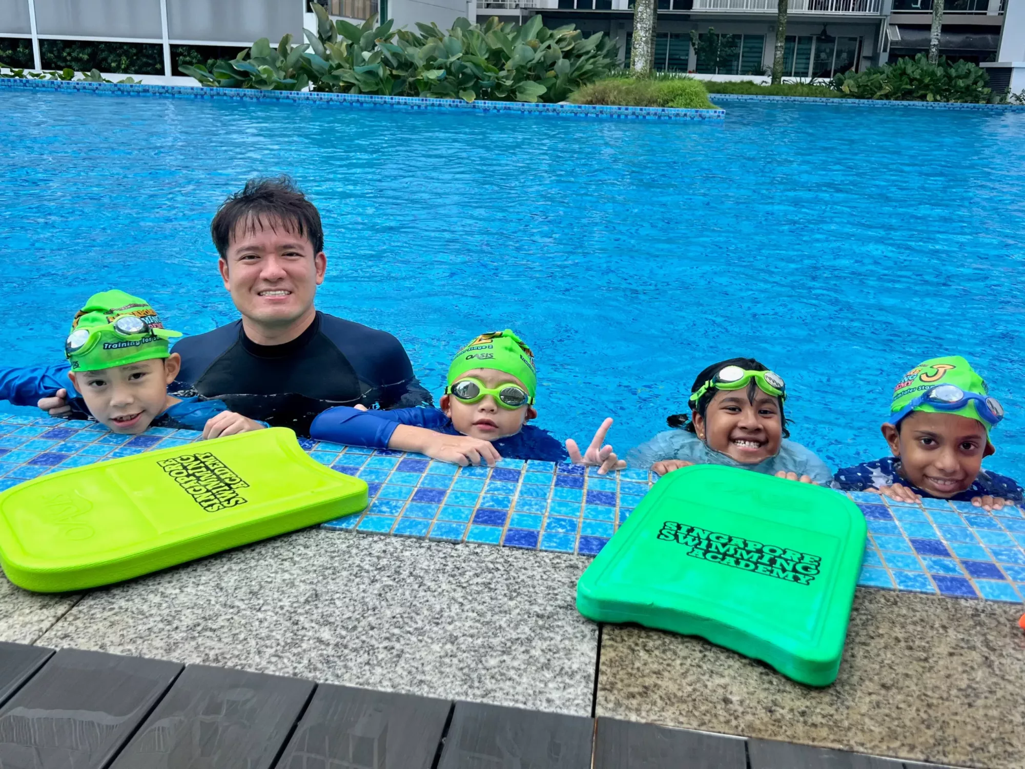 condo_swimming_lessons Children learning to swim in a condominium pool during group lessons in Singapore